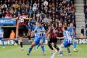 Enes Unal heads home Cherries' second goal against Brighton at Dean Court last season.