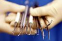 Photo of a dental nurse holding dental instruments