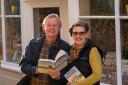 Martin Clunes presents a signed copy of his new book to Harriet Laurie, co-founder of Weymouth charity TheHorseCourse