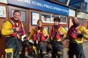 Poole RNLI volunteers with their Blue Peter badges and Joel