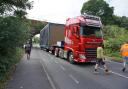 A second tractor was forced to make the tight squeeze under the bridge