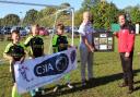 Matt Horan (left) receives a presentation plaque from Greg Partridge, manager of Dexter’s Under 11 Lions, with three of the players looking on