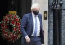 Boris Johnson outside a festive Downing Street. Credit: PA