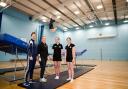 PE teacher Laura Greening, Head of PE Charlotte Warren and students at Parkstone Grammar School with their new trampoline and end deck