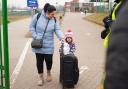 A family crossing the border point from Ukraine into Medyka, Poland. Photo via PA/Victoria Jones.