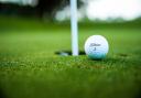 A golf ball by the hole. Credit: Canva