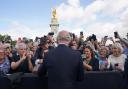 King Charles III is greeted by well-wishers during a walkabout to view tributes left outside Buckingham Palace, London, following the death of Queen Elizabeth II on Thursday.