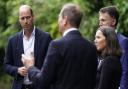 The Prince of Wales (left) chats with members of council and community groups during a visit to Faithworks Carpentry Workshop