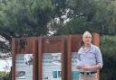 Vice chairman of FCRA, Paul De Jonghe. in front of one of the totem boards.