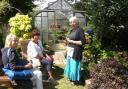 Christine Oliver talks to two visitors at her garden which was one of those open.