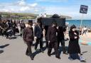 Funeral for nature procession running through Swanage