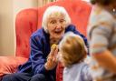 Brook View resident Diana Pearce with a young visitor