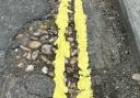 Double yellow lines were painted through potholes in Avenue Road, Lymington