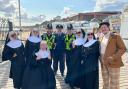 The cast joined officers in spreading safety messages on the beach.