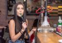 A woman smoking a shisha pipe