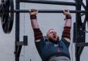 Matthew Smyth on his way to the axle overhead press event win, lifting 142.5kg, at the strongman competition in 2023.