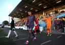 England's Taylor Harwood-Bellis leads out the team before the UEFA Euro U21 Championship Qualifying match at the Ballymena Showgrounds, County Antrim. Picture date: Friday September 6, 2024.