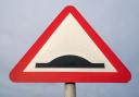 Road sign warning of speed bumps.