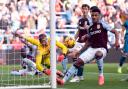 Bournemouth goalkeeper Mark Travers saves a header from Aston Villa's Amadou Onana