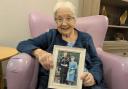 Rae, who lives at Talbot View care home, holding a picture of herself and husband Derrick