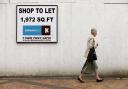 A woman makes her way past an empty shop in Stockport. The number of vacant shops blighting the UK's high streets and shopping centres has continued to rise, a report revealed today, amid grim warnings that some will never fully recover.