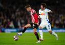 Sheffield United's Oliver Arblaster (left) and Leeds United's Joe Rothwell battle for the ball during the Sky Bet Championship match at Elland Road, Leeds. Picture date: Friday October 18, 2024.