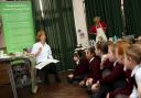 Pupils at The Priory School get involved in cooking at the school as part of the Christchurch Food Festival Education Trust programme. Pictured is Mary Reader, president of the festival, with year five pupils.