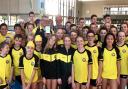 SUCCESS: Poole swimmers surround Barry Alldrick as he receives his South West Coach of the Year trophy from regional president Bob Holman