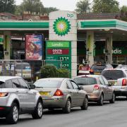 Vehicles queue up outside a BP petrol station Picture: Andrew Matthews/PA