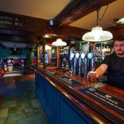 A pint in served at this pub over Christmas. Photo via PA.