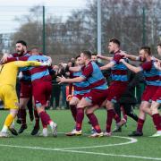 Hamworthy players celebrate victory after the FA Vase quarter-final tie between Hamworthy United and Southall on Sat 12th March 2022 at The County Ground, Hamworthy, Dorset. Photo: Ian Middlebrook.