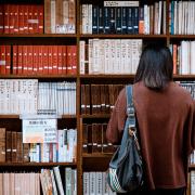 A student browsing books in the library. Credit: Canva