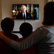 Ben, Isaac and Krystyna Rickett watching a broadcast of King Charles III first address to the nation as the new King following the death of Queen Elizabeth II on Thursday.