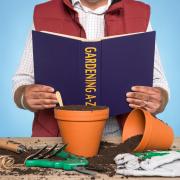 Generic picture of a gardener reading a gardening book. See PA Feature GARDENING Advice Book. Picture credit should read: Alamy/PA.