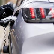 An electric car plugged into an EV charging point