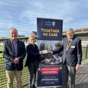 Rotarian Neil Hutchinson, Julia's House Fundraiser, Katie Thompson, and Wimborne Rotary president Graham West.