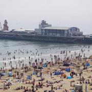 Thousands flock to soak up sun on sand in first warm weekend of the year