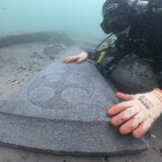 Diver with one of the gravestones.