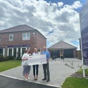 Taylor Wimpey Southern Counties Sales Executive Georgia (middle), with Peter Myres (right) and Hannah (left) from St Barnabas Church