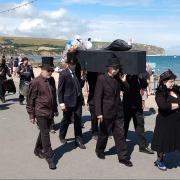 Funeral for nature procession running through Swanage