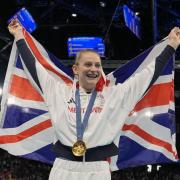 Bryony Page of Britain celebrates after winning the gold medal during the women's trampoline finals in Bercy Arena at the 2024 Summer Olympics, Friday, Aug. 2, 2024, in Paris, France. (AP Photo/Charlie Riedel).