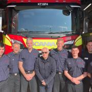 Neil Duncan-Jordan (centre) with firefighters in Poole