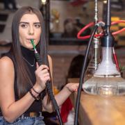 A woman smoking a shisha pipe