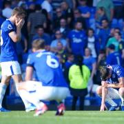 Everton's Michael Keane (right) and team-mates look dejected following defeat in the Premier League match at Goodison Park, Liverpool. Picture date: Saturday August 31, 2024.