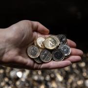 Undated handout photo issued by the Royal Mint of the new pressing of the one pound coin bearing King Charles III's official portrait  at the Royal Mint in Llantrisant, South Wales.  This week, the first £1 coin bearing the King's official coin portrait