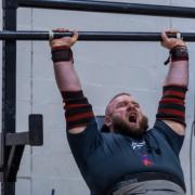 Matthew Smyth on his way to the axle overhead press event win, lifting 142.5kg, at the strongman competition in 2023.