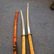 Two men arrested after police seize large samurai swords in West Howe