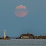 The harvest supermoon over Portland Breakwater