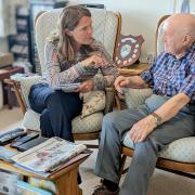 Vikki Slade speaking to a pensioner