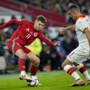 Wales' David Brooks (left) and Montenegro's Nikola Krstovic (right) battle for the ball during the